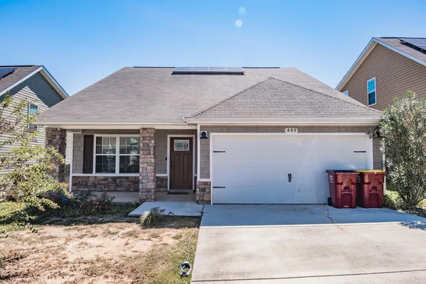 a front view of a house with a yard and garage