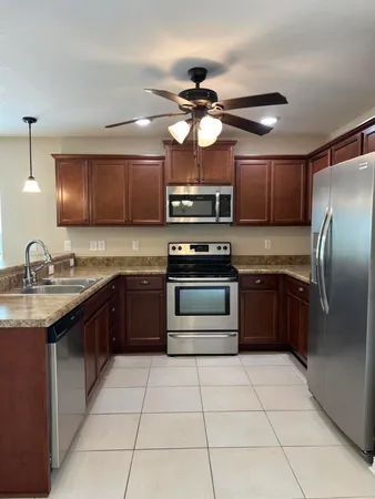 a kitchen with a sink a stove and oven