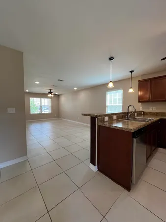 a kitchen with kitchen island granite countertop a sink and a stove