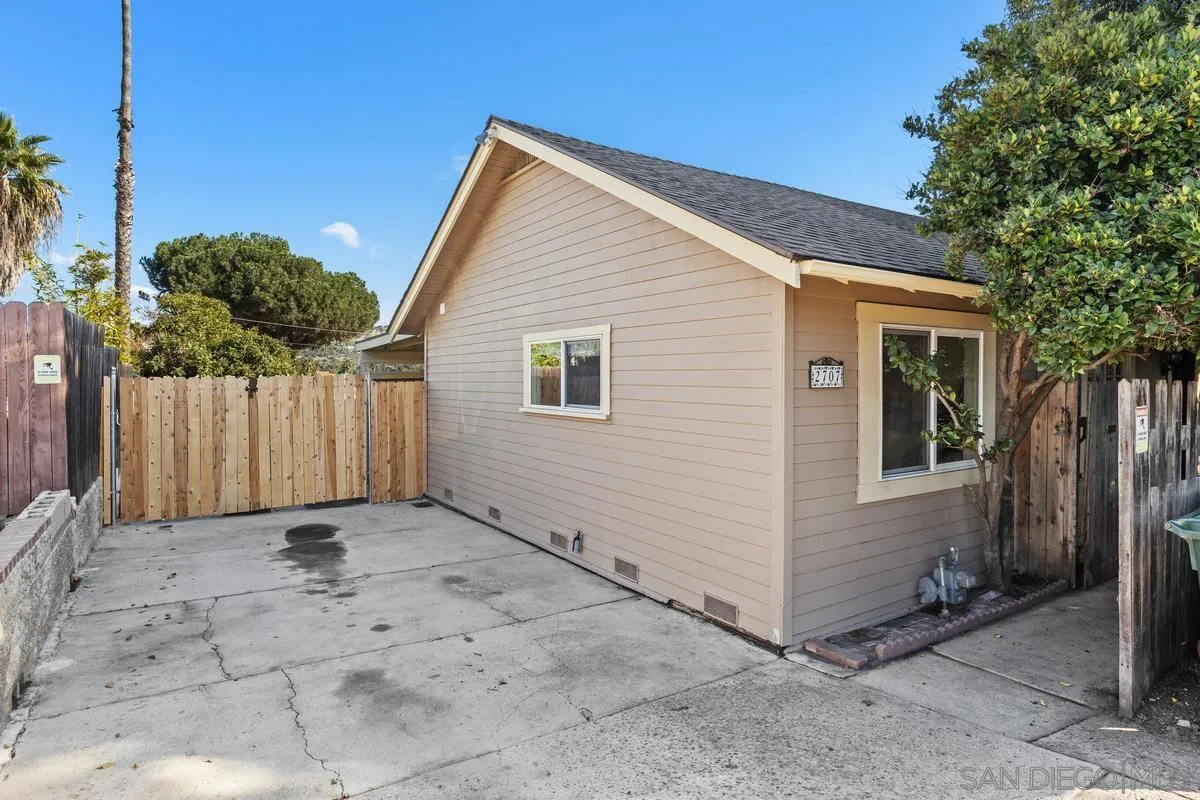 2707 Sweetwater Road Spring Valley, CA 91977 - Photo 27 of 30 a view of a house with a small yard and wooden fence