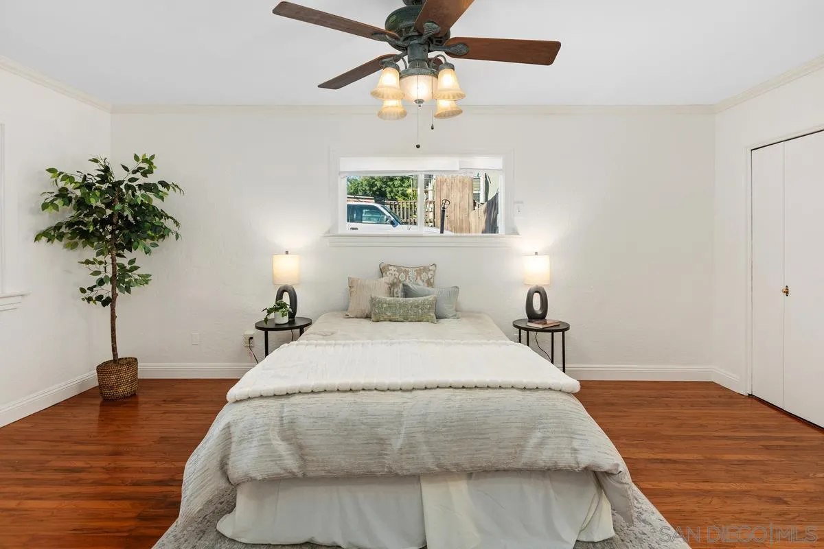 2707 Sweetwater Road Spring Valley, CA 91977 - Photo 5 of 30 a bedroom with a bed chandelier and a potted plant