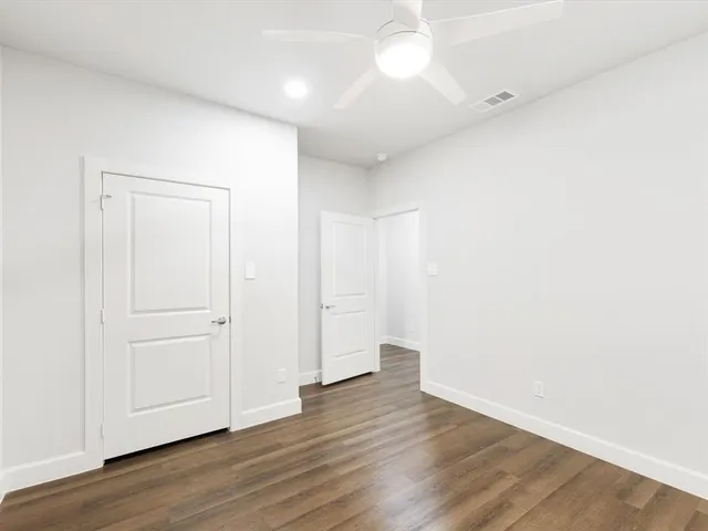 an empty room with wooden floor