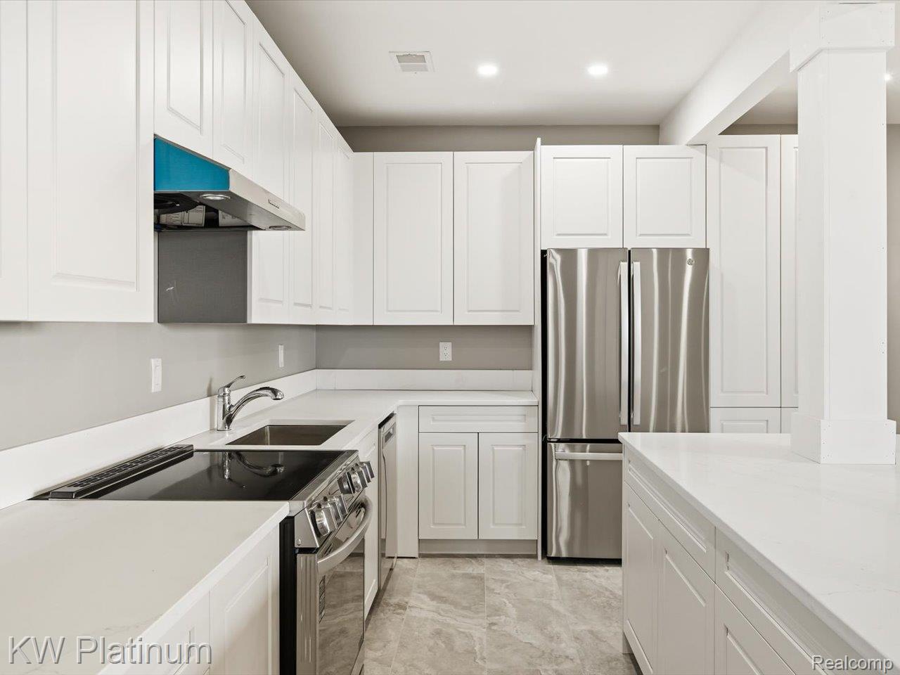 493 Wood Road Snover, MI 48472 - Photo 35 of 60 lower level contemporary kitchen featuring pristine white cabinetry, light countertops, stainless steel appliances, and recessed lighting