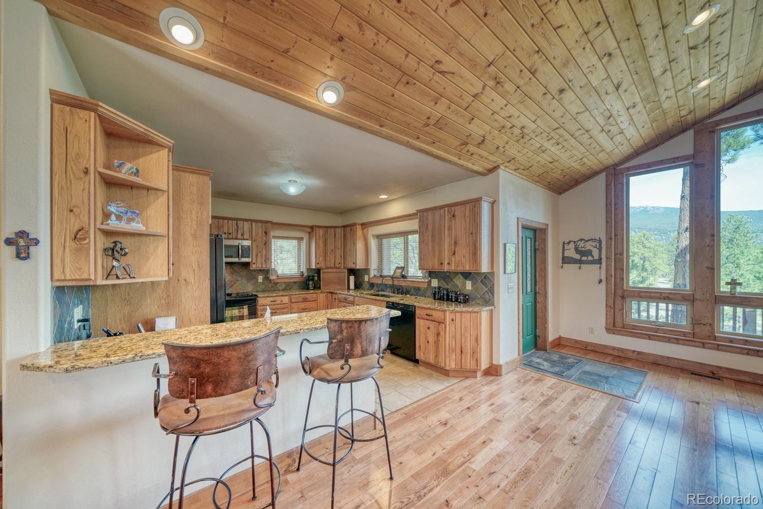 30800 West Ridge Road Buena Vista, CO 81211 - Photo 11 of 49 a kitchen with a sink and wooden cabinets