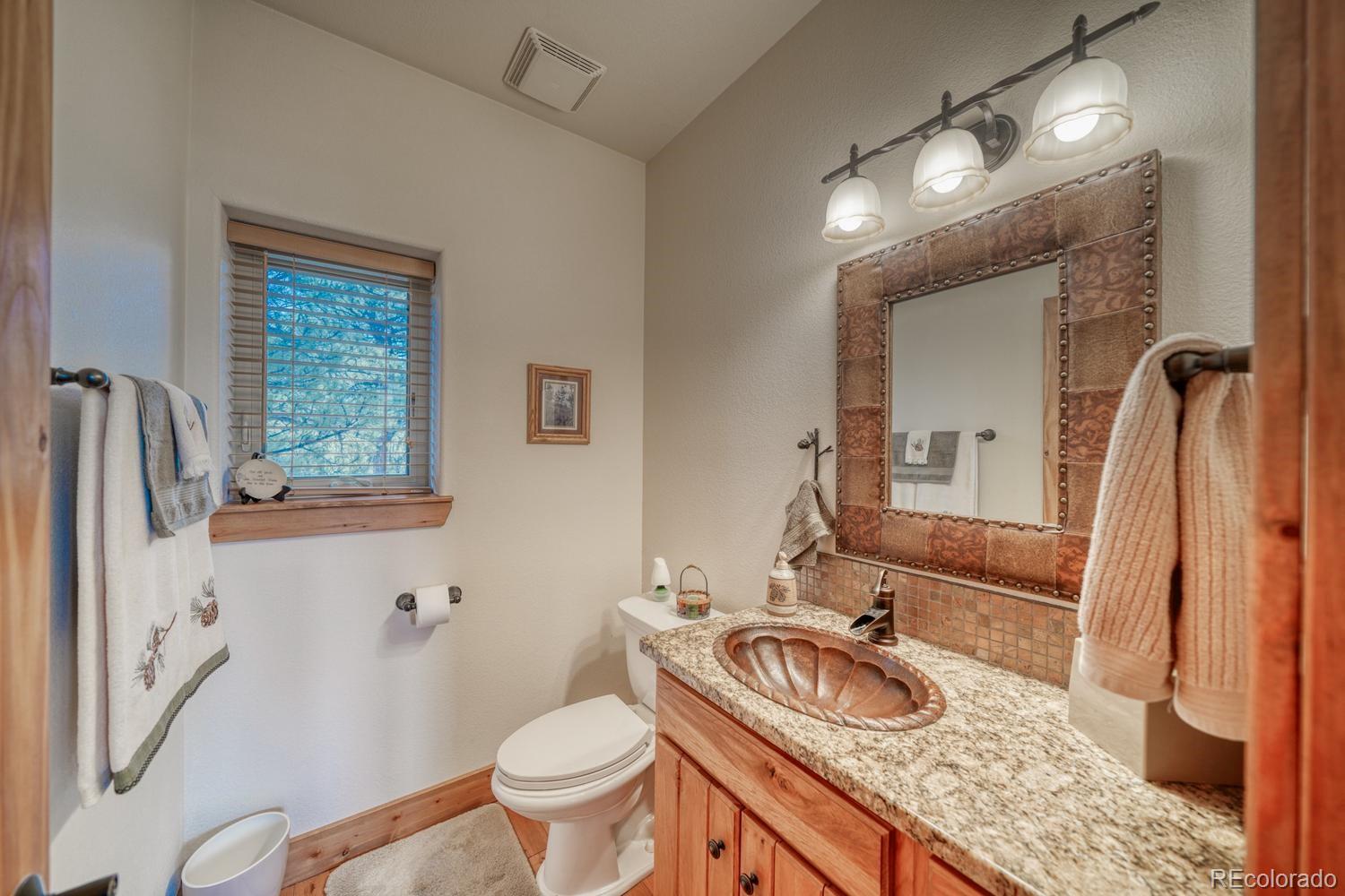 30800 West Ridge Road Buena Vista, CO 81211 - Photo 24 of 49 a bathroom with a granite countertop sink toilet and a mirror