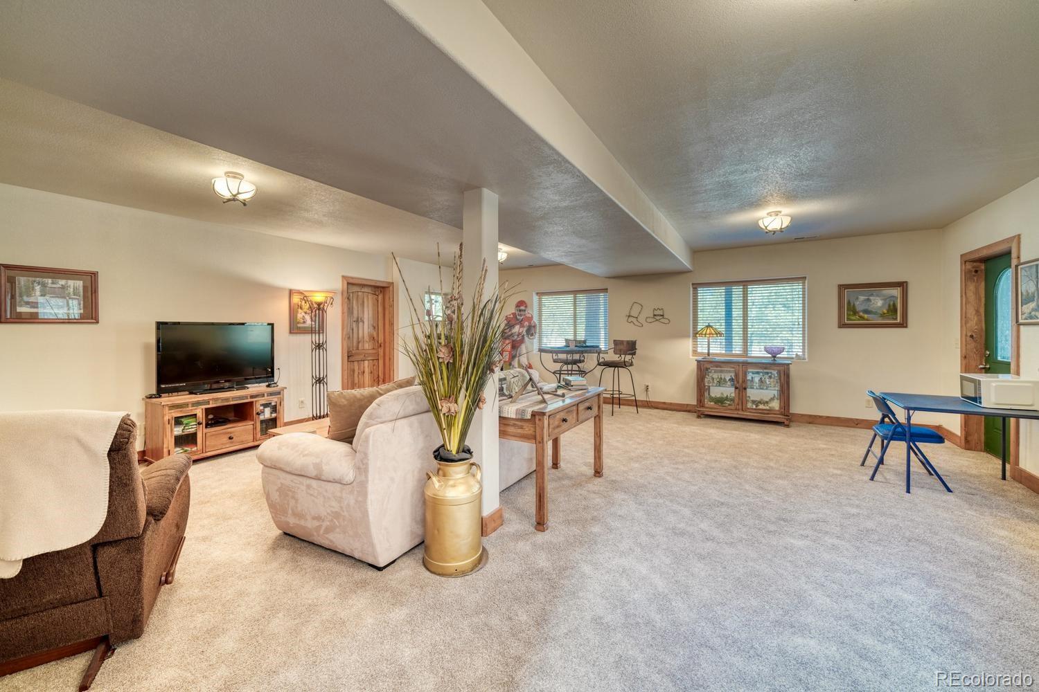 30800 West Ridge Road Buena Vista, CO 81211 - Photo 28 of 49 a living room with furniture and a flat screen tv