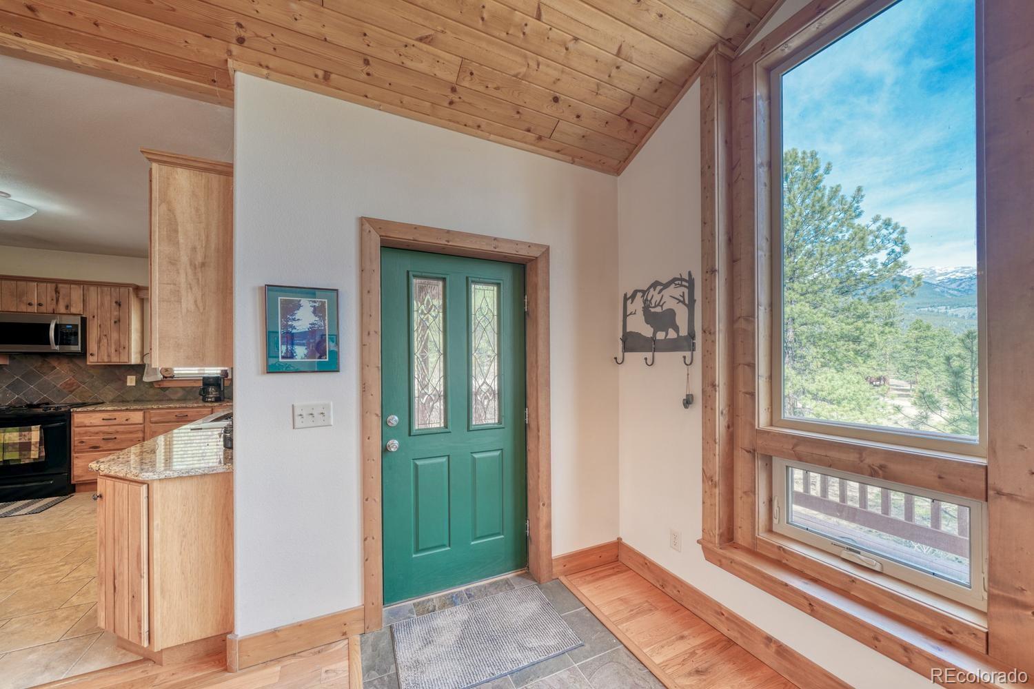 30800 West Ridge Road Buena Vista, CO 81211 - Photo 4 of 49 a view of a hallway with wooden floor and a livingroom