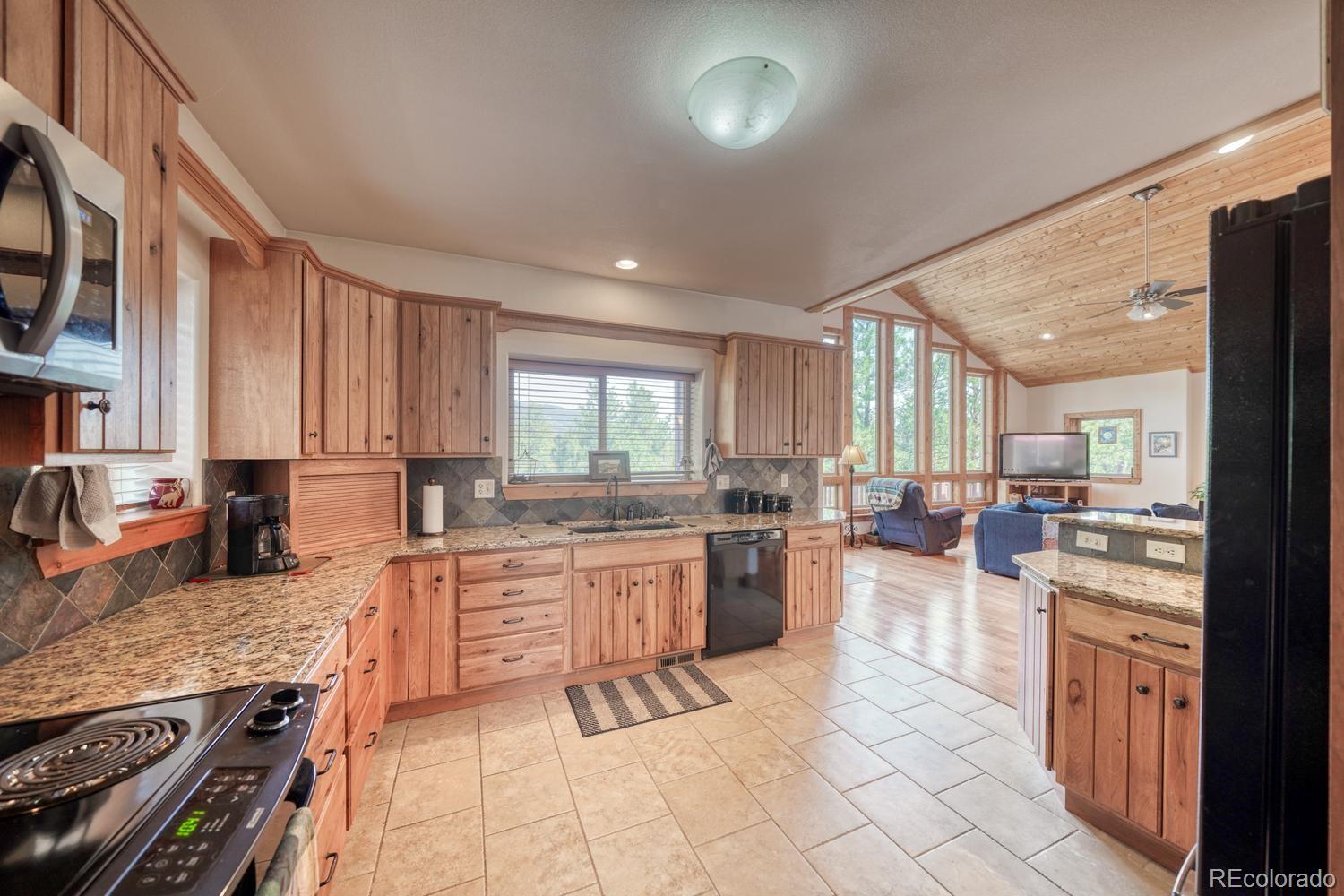 30800 West Ridge Road Buena Vista, CO 81211 - Photo 9 of 49 a large kitchen with lots of counter top space and stainless steel appliances
