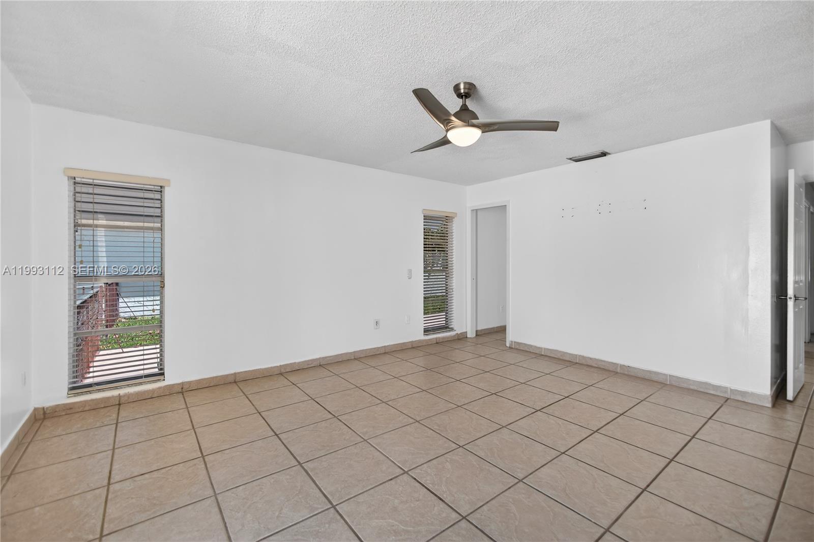 13471 Southwest 99th Terrace Miami, FL 33186 - Photo 21 of 44 a view of an empty room and window