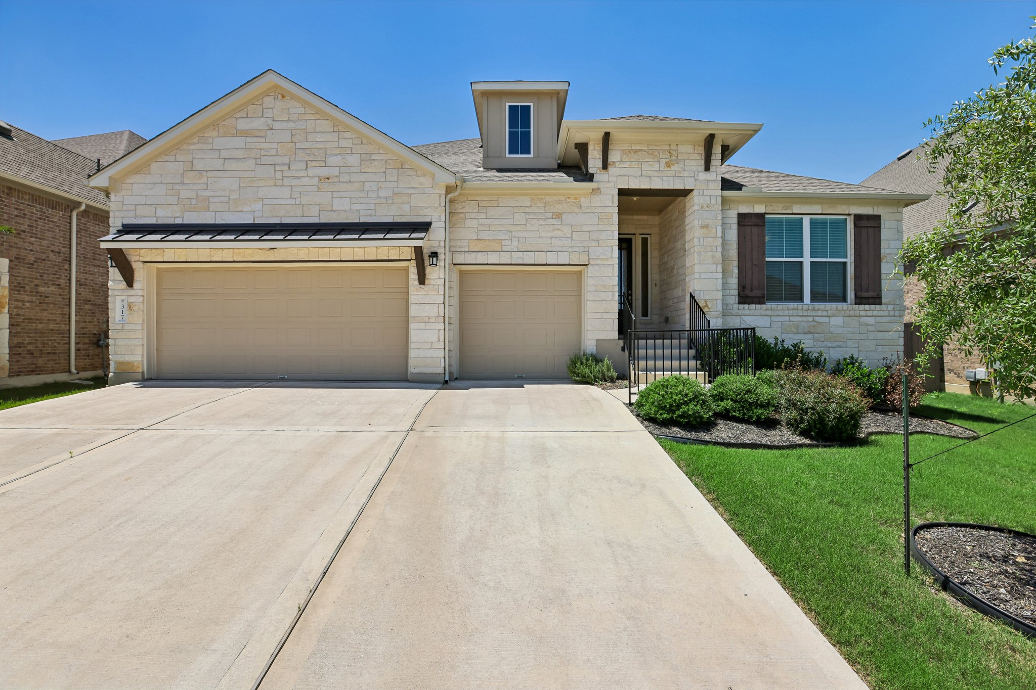 317 Independence Drive Kyle, TX 78640 - Photo 3 of 40 a front view of a house with yard
