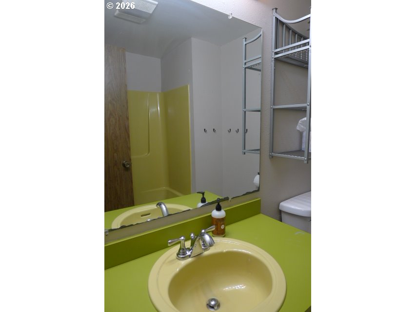 412 Camellia Court Reedsport, OR 97467 - Photo 35 of 48 a bathroom with a sink and a mirror