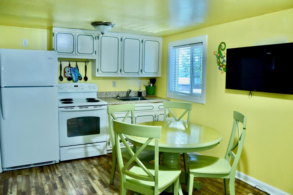 5641 Eastport Road Alpine, TN 38543 - Photo 13 of 15 a kitchen with stainless steel appliances granite countertop a sink a microwave cabinets and a dining table