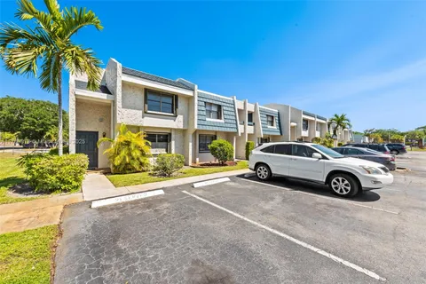 a view of a car parked in front of a house