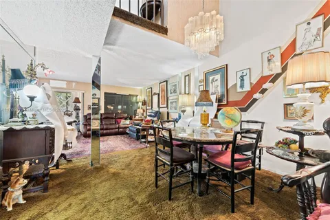 a dining room with furniture and a chandelier