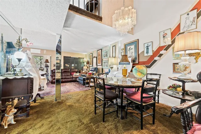 a dining room with furniture and a chandelier