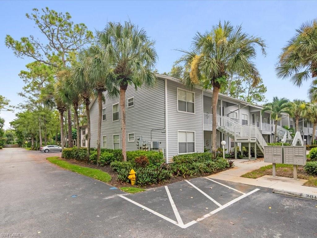 a view of a white house with a yard and plant