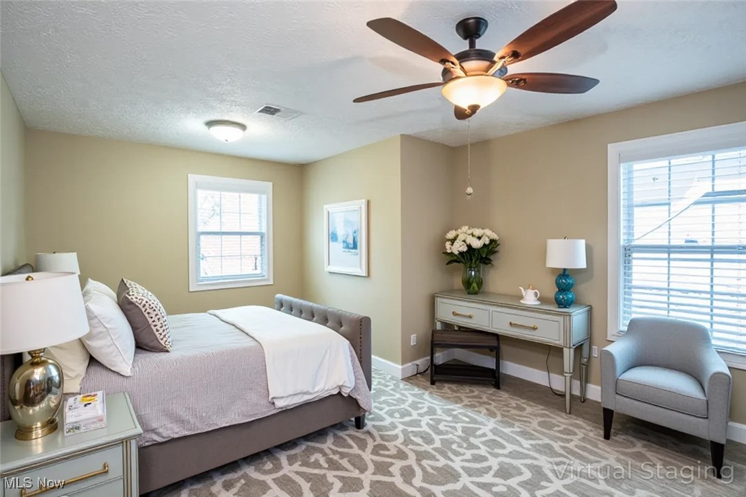 630 Rundle Street Lagrange, OH 44050 - Photo 32 of 49 Bedroom featuring a textured ceiling, light carpet, and a ceiling fan