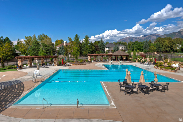16 Gatehouse Lane Sandy, UT 84092 - Photo 63 of 73 Community pool with a pergola, a patio, and a mountain view