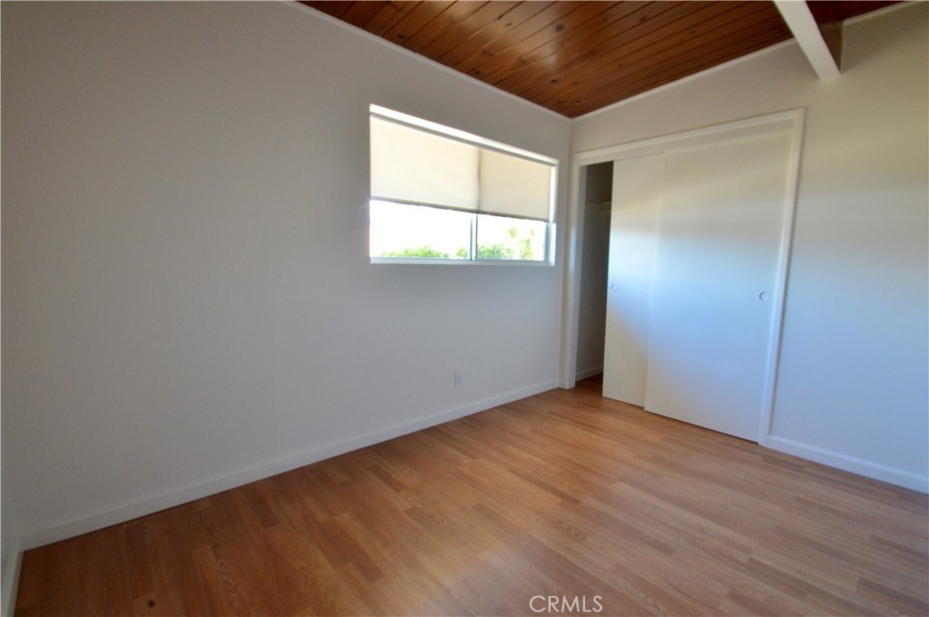 3175 Studio Drive Cayucos, CA 93430 - Photo 12 of 20 an empty room with wooden floor and windows