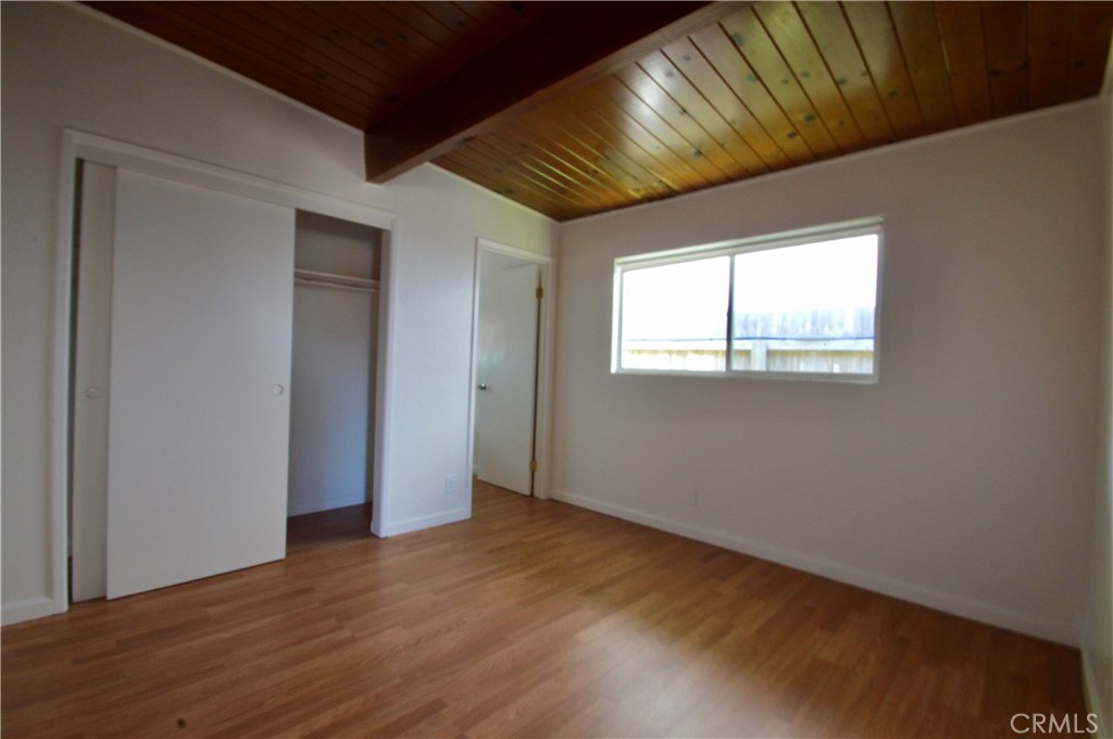 3175 Studio Drive Cayucos, CA 93430 - Photo 9 of 20 an empty room with wooden floor and windows