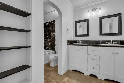 a bathroom with a toilet a sink and a mirror