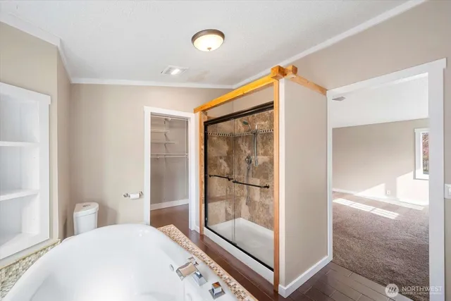 a bedroom with a bed and glass door