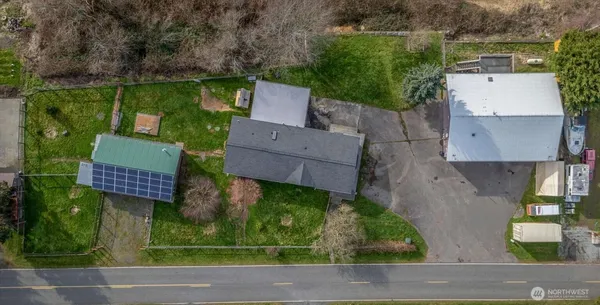 an aerial view of a house with garden space and street view
