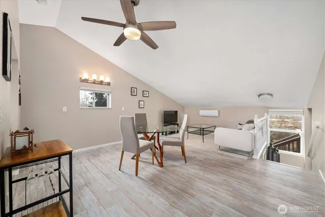 a view of a dining room with furniture and wooden floor