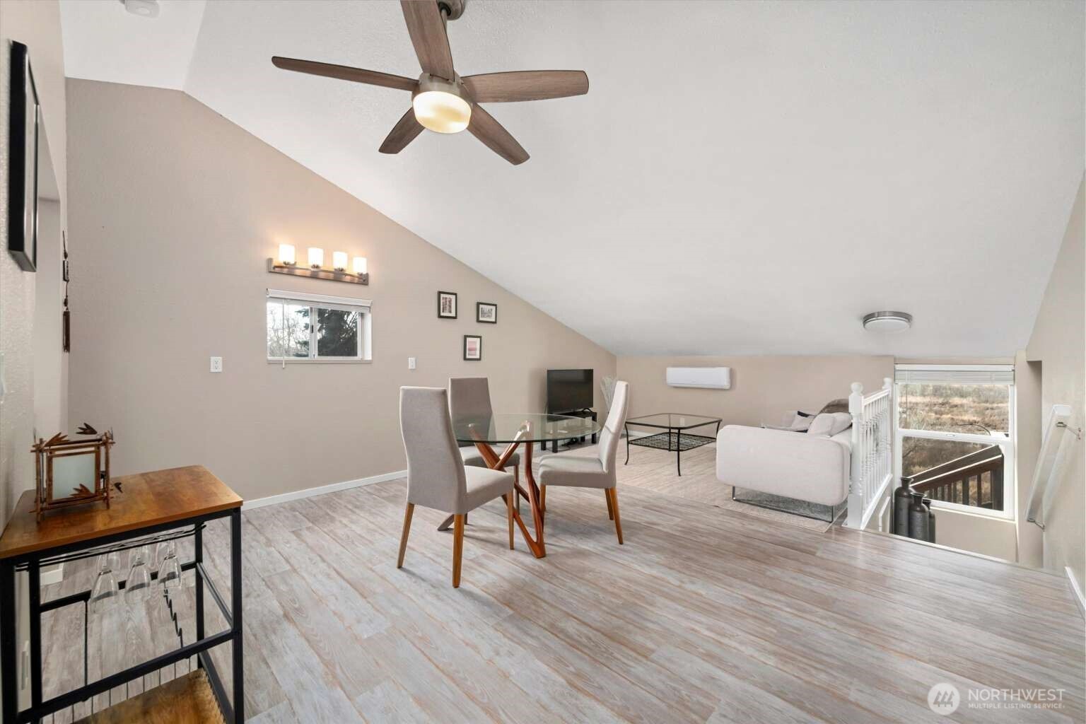 4241 Rural Avenue Bellingham, WA 98226 - Photo 27 of 40 a dining room with wooden floor a chandelier fan a wooden table and chairs