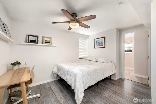 a spacious bathroom with a granite countertop sink a toilet and a window