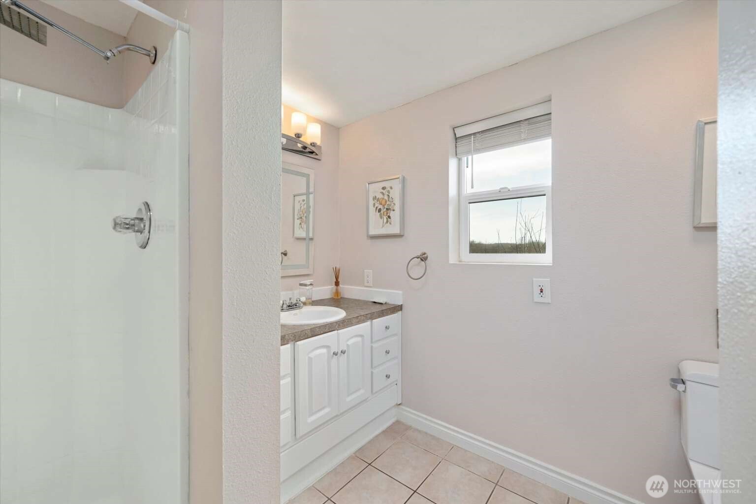 4241 Rural Avenue Bellingham, WA 98226 - Photo 34 of 40 a spacious bathroom with a granite countertop sink a toilet and a window