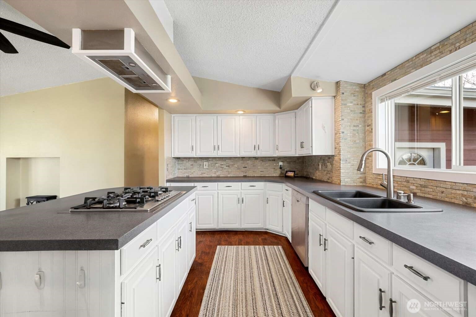 4241 Rural Avenue Bellingham, WA 98226 - Photo 7 of 40 a kitchen with granite countertop a sink stove and cabinets