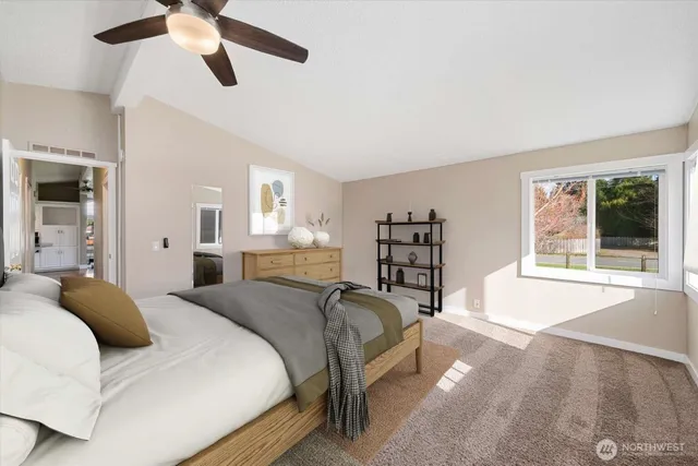 a spacious bedroom with a bed and a large window