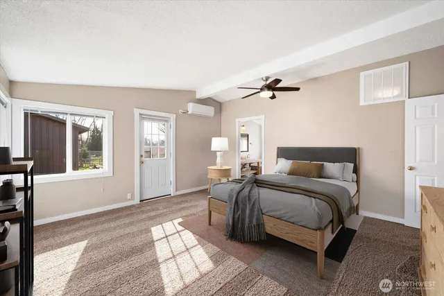 a bedroom with a bed cabinet and a window