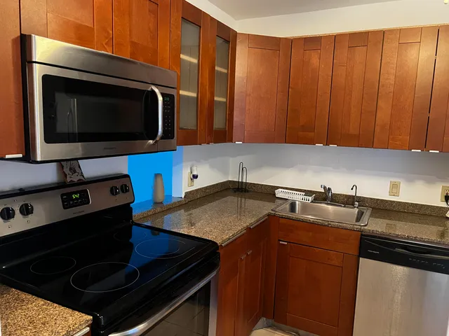 a kitchen with a stove microwave and sink