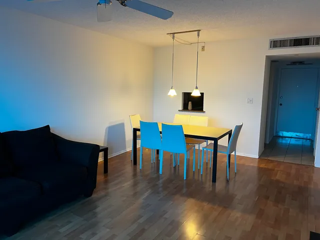 a view of a workspace with furniture and wooden floor