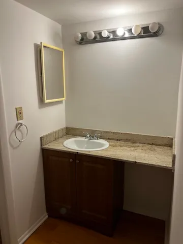a bathroom with a sink and mirror