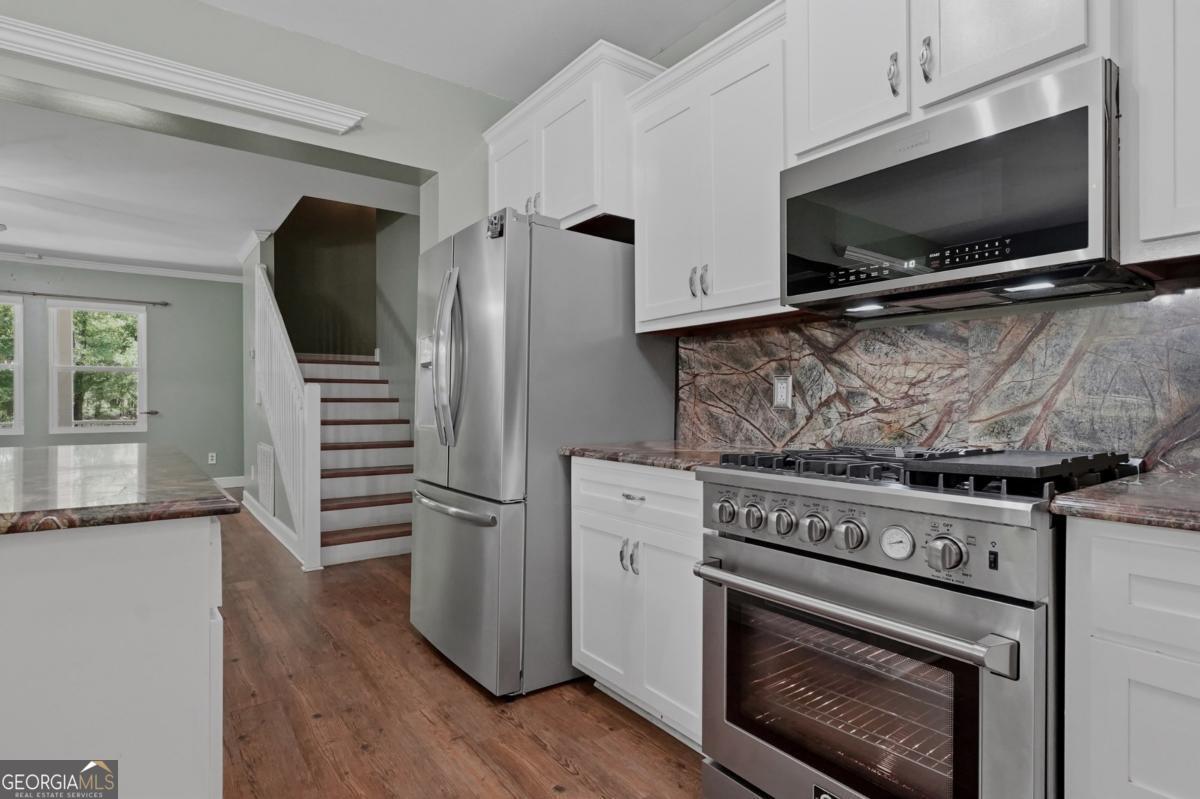 609 Morgan Street Albany, GA 31705 - Photo 15 of 74 a kitchen with cabinets and steel appliances