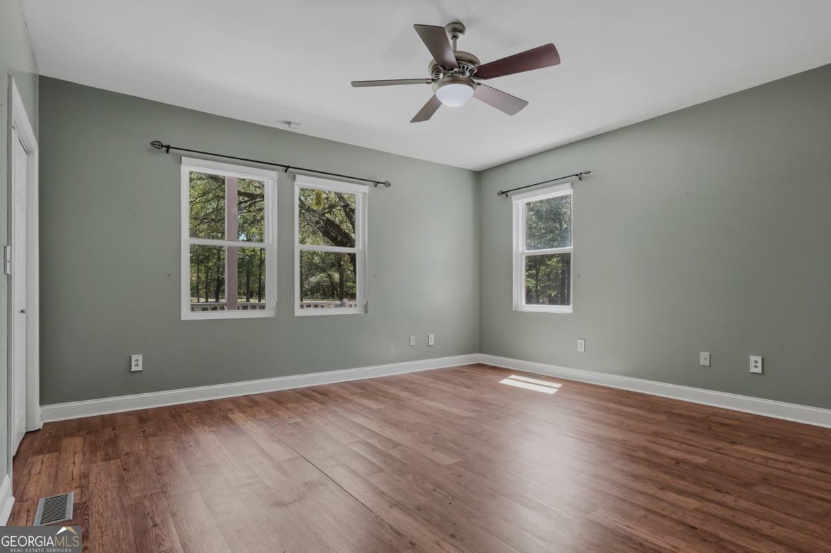 609 Morgan Street Albany, GA 31705 - Photo 17 of 74 a view of an empty room with wooden floor and a window
