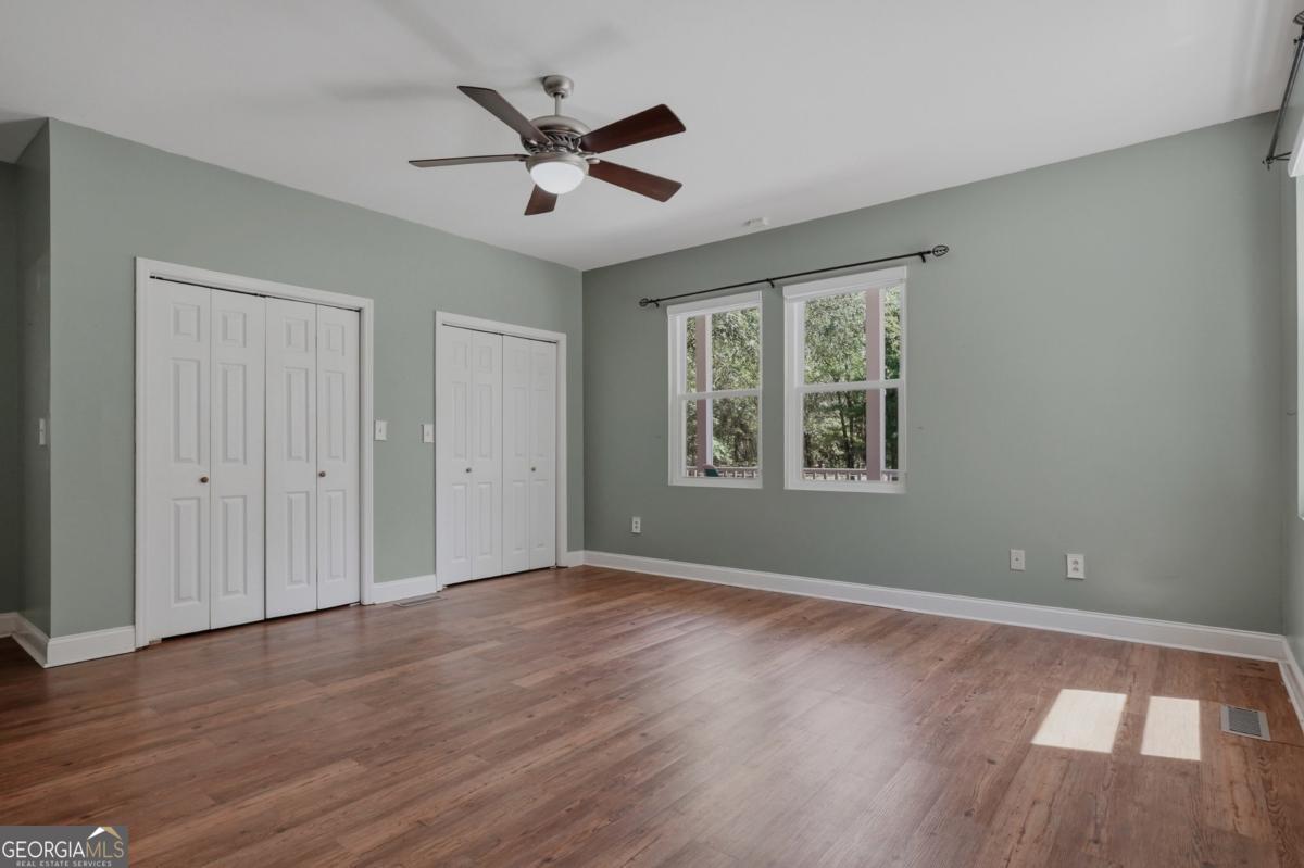 609 Morgan Street Albany, GA 31705 - Photo 19 of 74 a view of an empty room with wooden floor and a window
