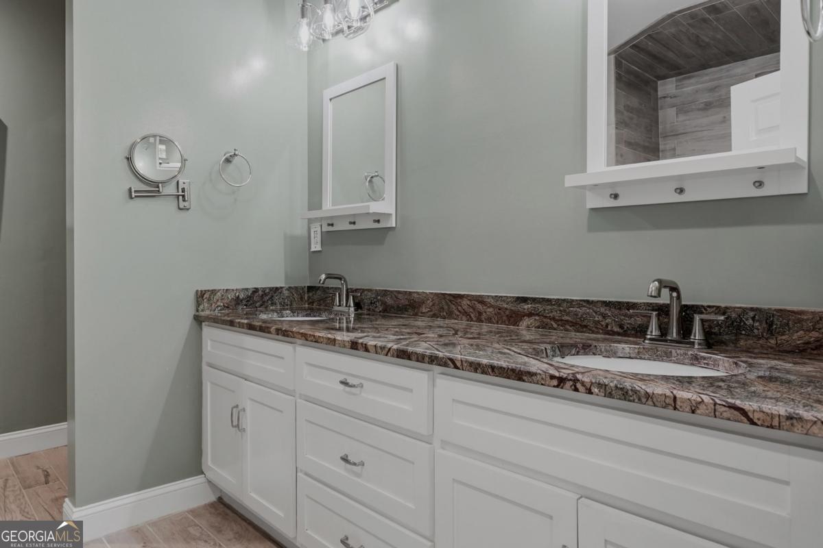 609 Morgan Street Albany, GA 31705 - Photo 20 of 74 a bathroom with a double vanity sink and mirror