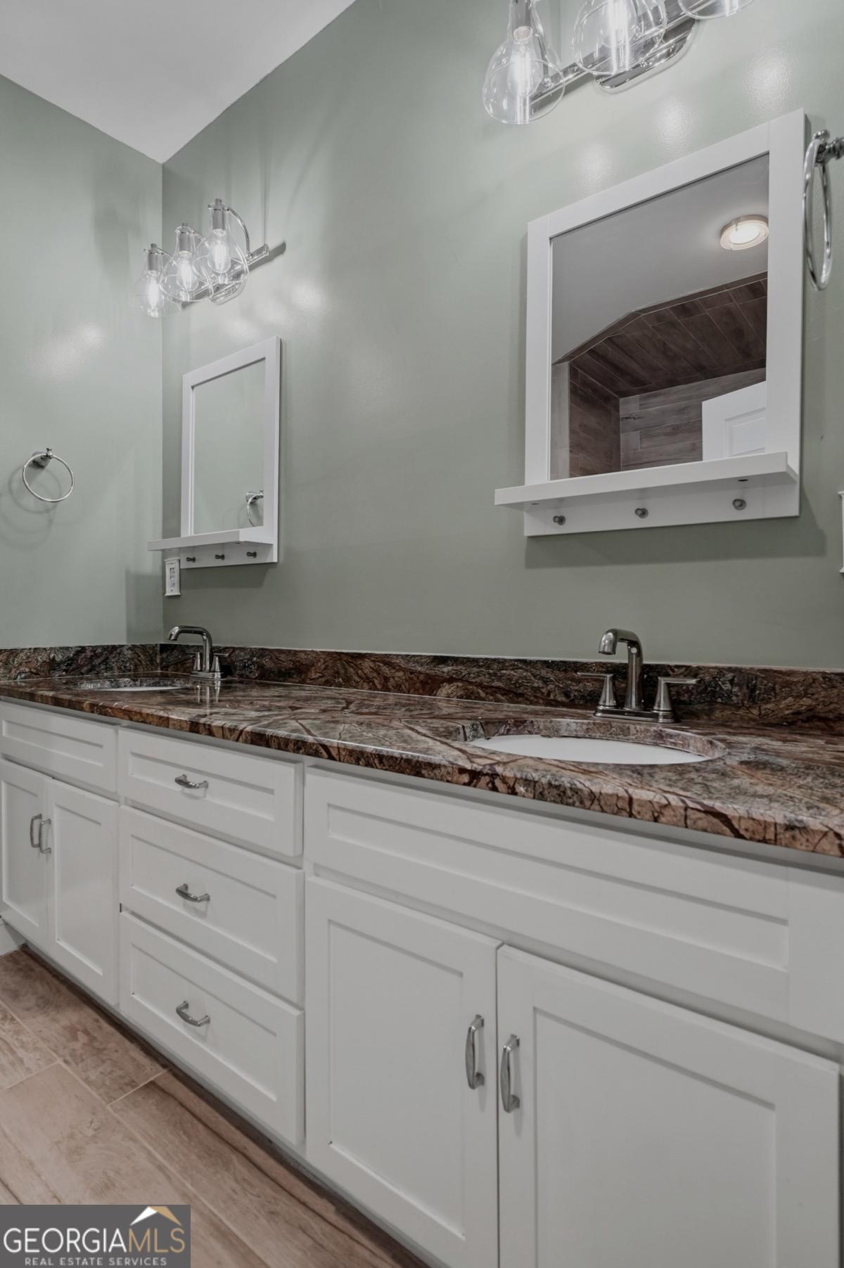 609 Morgan Street Albany, GA 31705 - Photo 22 of 74 a bathroom with a sink and two mirror