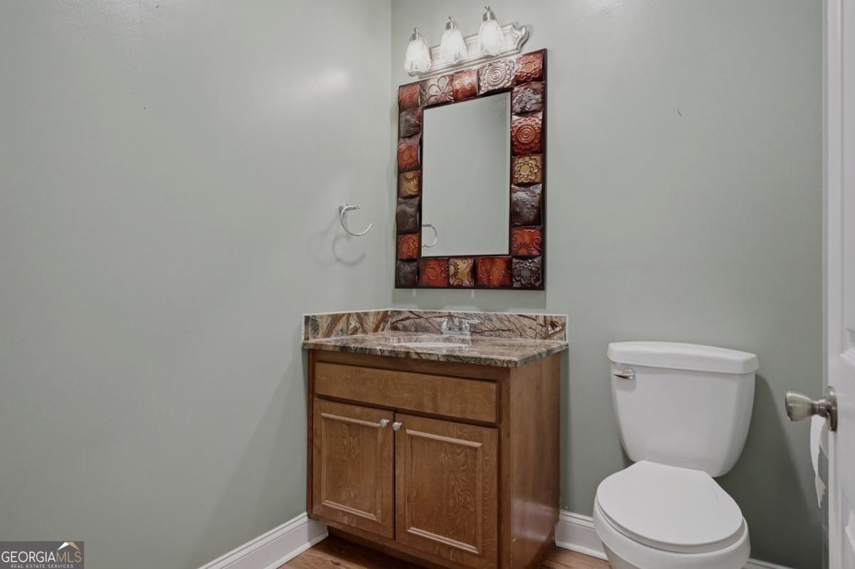 609 Morgan Street Albany, GA 31705 - Photo 27 of 74 a bathroom with a toilet sink and mirror