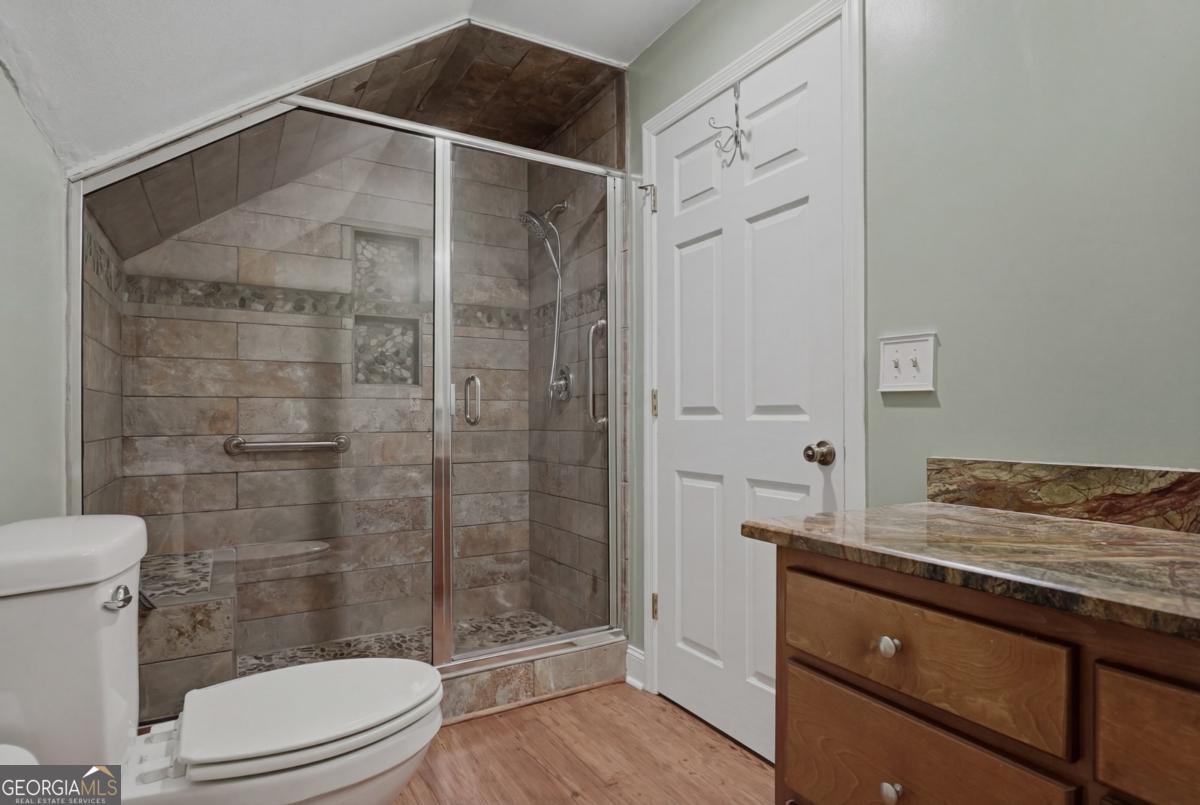 609 Morgan Street Albany, GA 31705 - Photo 35 of 74 a bathroom with a granite countertop sink a toilet and shower