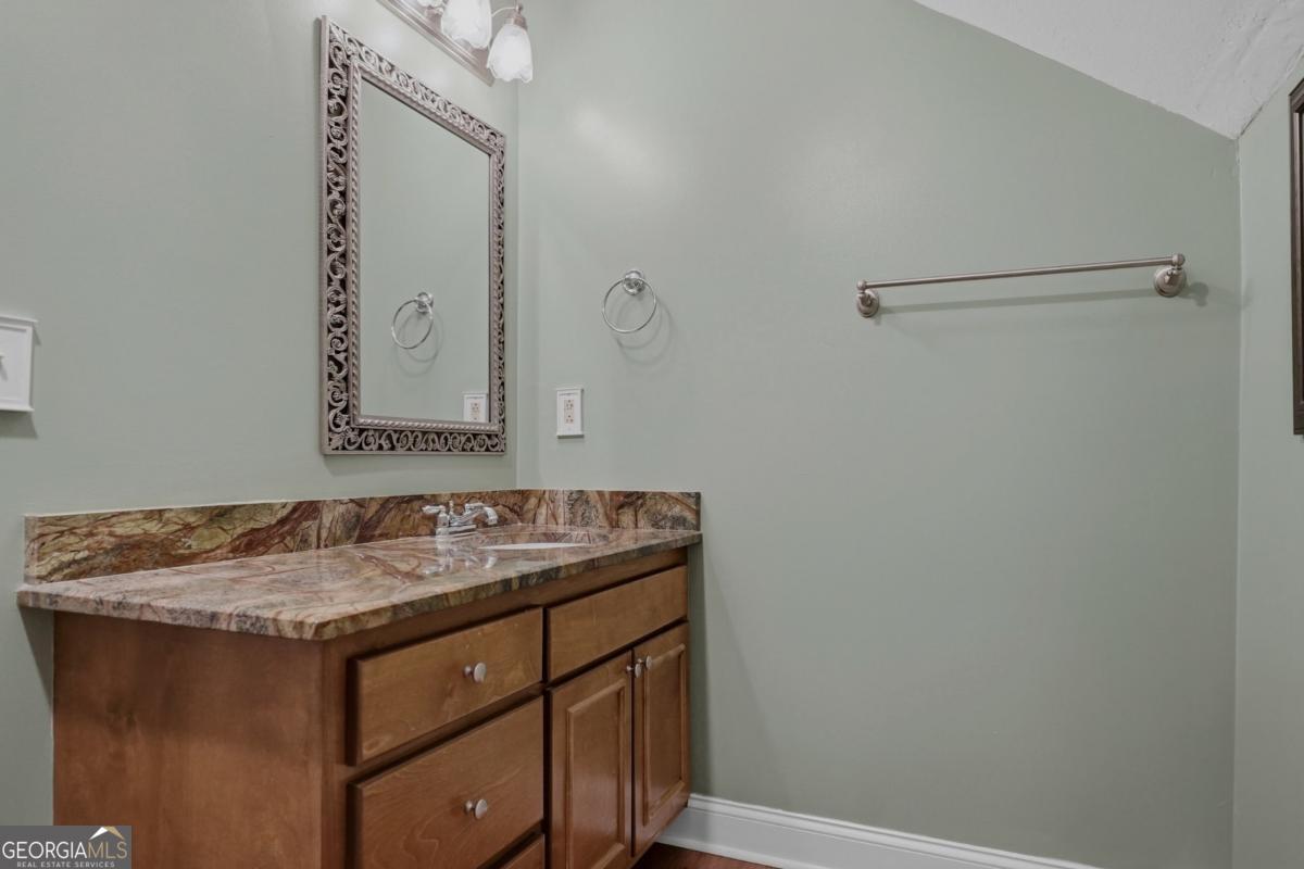 609 Morgan Street Albany, GA 31705 - Photo 36 of 74 a bathroom with a granite countertop sink and a mirror