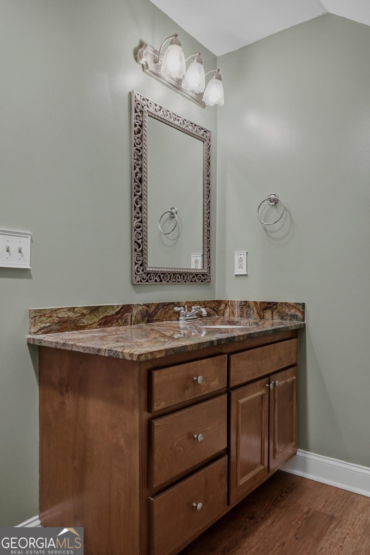 609 Morgan Street Albany, GA 31705 - Photo 38 of 74 a bathroom with a granite countertop sink a mirror and vanity