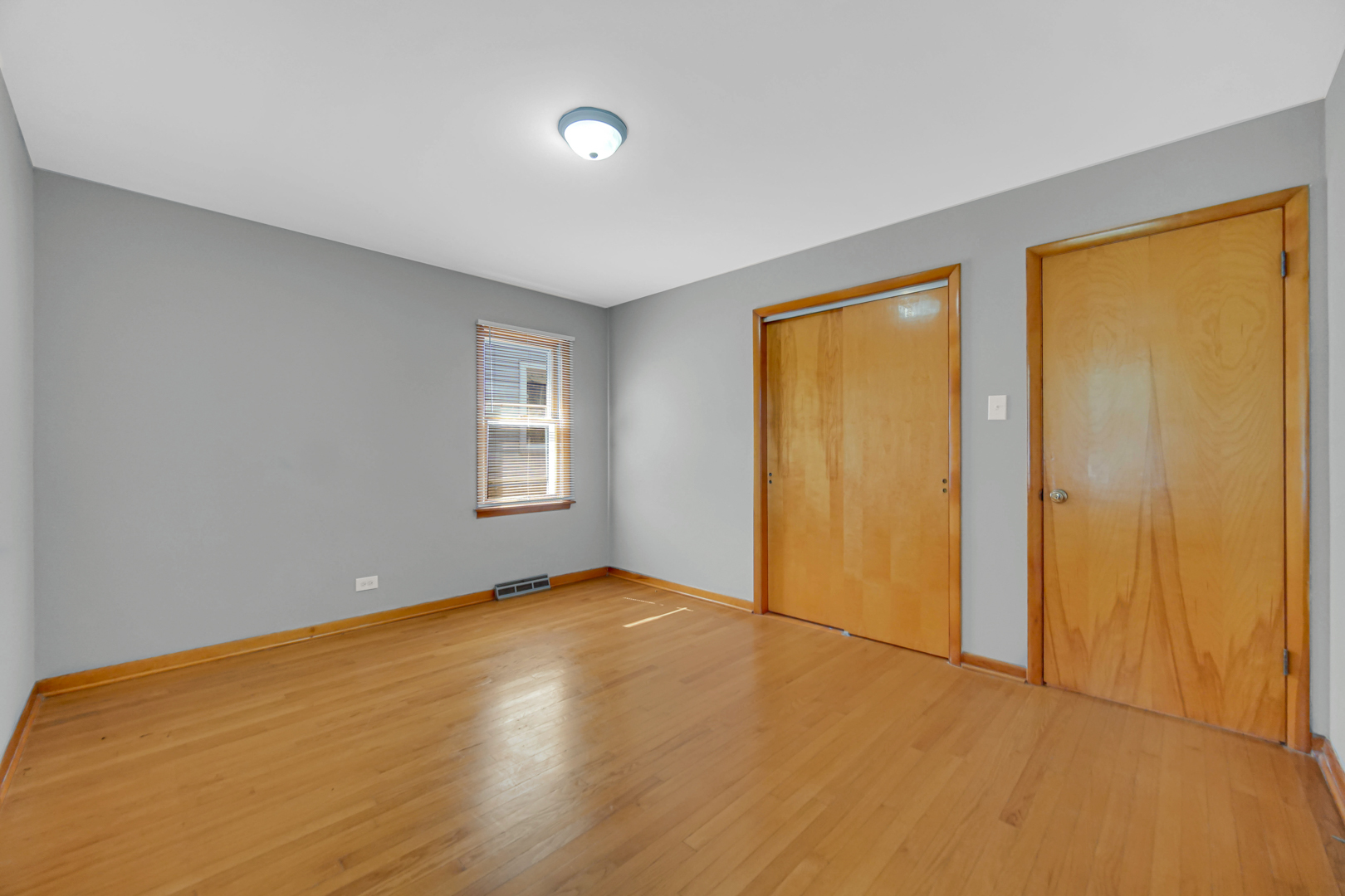2621 Ridge Road Lansing, IL 60438 - Photo 13 of 20 a view of an empty room with wooden floor and a window