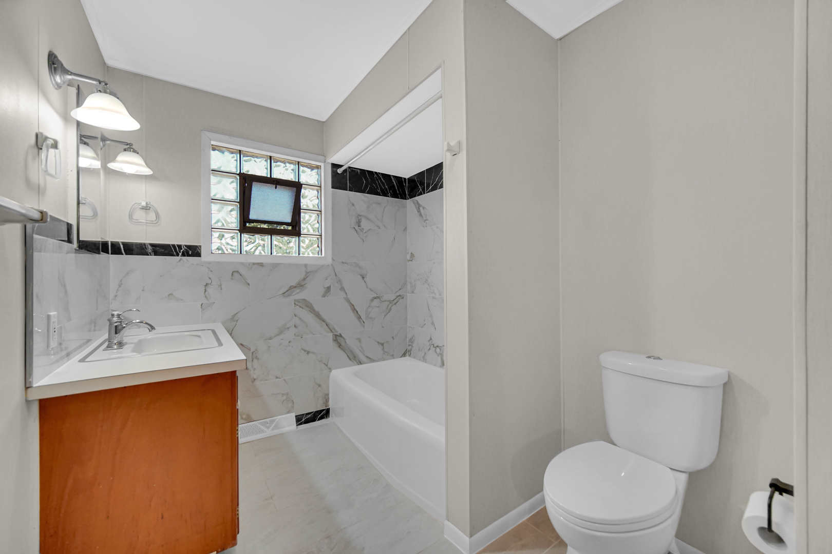 2621 Ridge Road Lansing, IL 60438 - Photo 16 of 20 a bathroom with a granite countertop sink toilet and shower