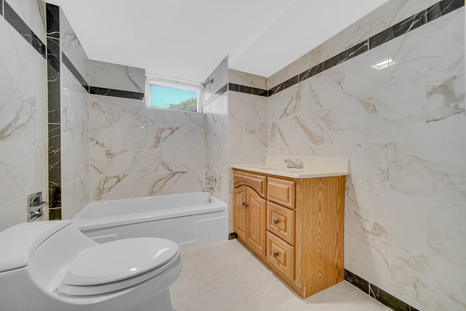 2621 Ridge Road Lansing, IL 60438 - Photo 18 of 20 a bathroom with a sink a toilet and bathtub