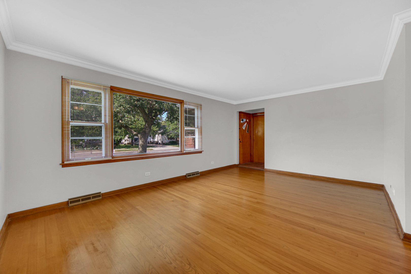 2621 Ridge Road Lansing, IL 60438 - Photo 5 of 20 a view of an empty room with wooden floor and a window